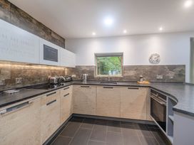 A kitchen with appliances and a window at St Austell Lodge Spa in Praze-An-Beeble