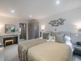 A bedroom with two beds and a desk at St Austell Lodge Spa in Praze-An-Beeble