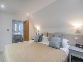 A bedroom with a bed and adjoining bathroom at St Austell Lodge Spa, Praze-An-Beeble
