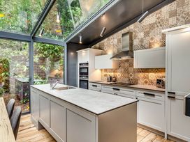 A kitchen with cabinets and kitchen island at The Gatehouse in Praze-An-Beeble