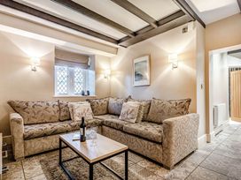 A living room with a sofa and coffee table at The Gatehouse in Praze-An-Beeble