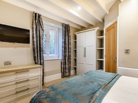 A bedroom with a television and wardrobe at The Gatehouse in Praze-An-Beeble