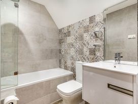 A bathroom with a bathtub and sink at The Gatehouse in Praze-An-Beeble