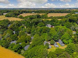 A landscape with houses among trees and fields at The Gatehouse in Praze-An-Beeble