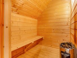 A sauna with wooden walls and a wooden bench at Woodland Lodge Spa in Praze-An-Beeble