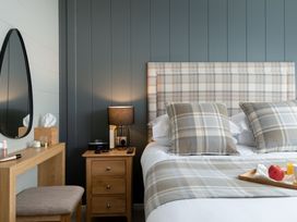 A bedroom with a bed and bedside table at Argel Spa in Praze-An-Beeble