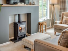 A living room with a fireplace and television at Argel Spa Pet Praze-An-Beeble