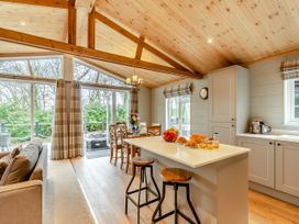 A kitchen with a dining area and sofa at Argel Spa Pet in Praze-An-Beeble