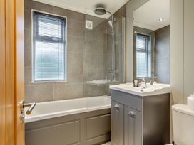 A bathroom with a shower and bathtub at Argel Spa Pet in Praze-An-Beeble