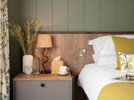 A bedroom with a bedside table and lamp at Kilden Pet in Praze-An-Beeble