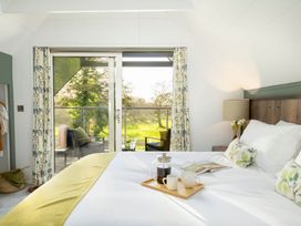 A bedroom with a bed and coffee setup at Lowarth Lodge Spa Pet Praze-An-Beeble