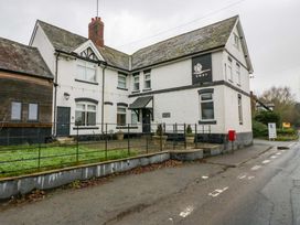 A building with a sign labeled SWAN and a garden at The Swan in 