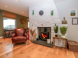A living room featuring a fireplace, chair, and table at The Swan