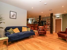 A lounge with a sofa and armchairs at The Swan 