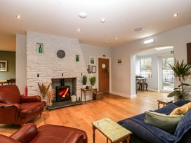 A sitting room with a fireplace and armchairs at The Swan