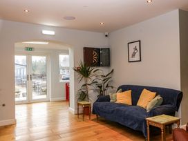 A lounge area with a sofa and dartboard at The Swan