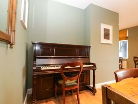 A living room with a piano and a chair at The Swan in 
