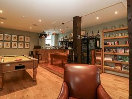 A game room with a pool table and a bar at The Swan