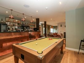 A game room with a pool table and bar at The Swan 