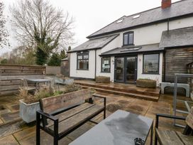 A patio area with seating and planters at The Swan in 