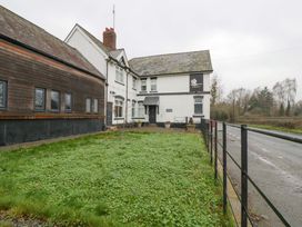 A building with a sign and fence at The Swan