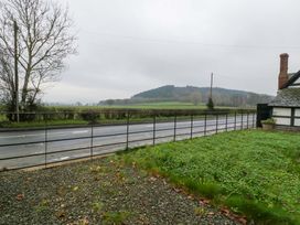 A view of a road and hill with trees at The Swan 