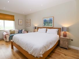 A bedroom with a bed and sofa at The Swan in Whitney-On-Wye
