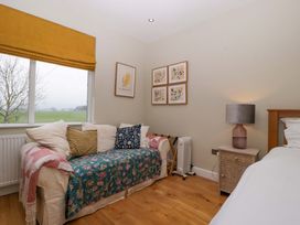 A bedroom with a sofa and lamp at The Swan in Whitney-On-Wye
