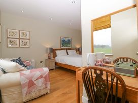 A bedroom with a bed, table, and sofa at The Swan in Whitney-On-Wye