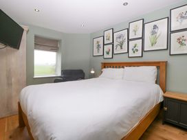 A bedroom with a bed and nightstand at The Swan in Whitney-On-Wye