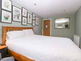A bedroom with a bed and wall art at The Swan in Whitney-On-Wye