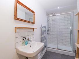 A bathroom with a sink, mirror, shower, and towel rail at The Swan in Whitney-On-Wye