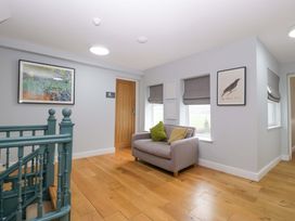 A hallway with a sofa and artwork at The Swan in Whitney-On-Wye