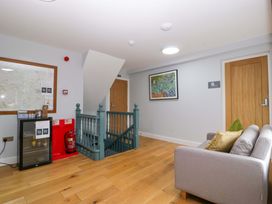 A hallway with a staircase and a sofa at The Swan in Whitney-On-Wye