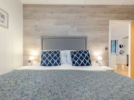 A bedroom with a bed and nightstands at Milk Wood 2 Laugharne