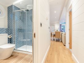A bathroom with a shower and toilet at Milk Wood 2 in Laugharne