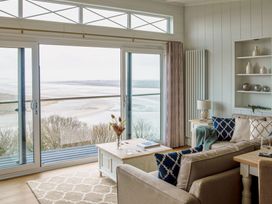 A living room with a view of the sea at Milk Wood 2 Spa in Laugharne