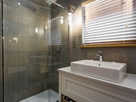 A bathroom with a shower and sink at Dylan Spa in Laugharne