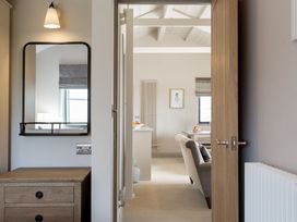 A hallway with a mirror and drawer unit at Dylan Spa in Laugharne