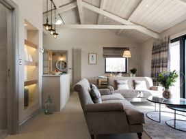 A living room with a sofa and coffee table at Dylan Spa in Laugharne