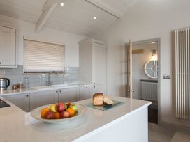 A kitchen with a fruit bowl and bread on the counter at Dylan Spa Laugharne