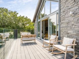 An outdoor deck with rocking chairs and a sofa at The View in Laugharne