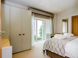 A bedroom with a bed and wardrobe at The View in Laugharne
