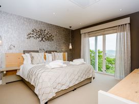 A bedroom with a bed and window at The View in Laugharne