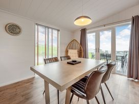 A dining room with a table and chairs at Sonnet 2 Spa in Laugharne