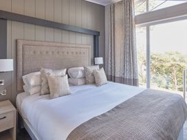 A bedroom with a bed and window at Milk Wood 3 in Laugharne