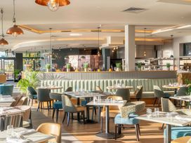 A restaurant with booth seating and a bar area at Milk Wood 3 in Laugharne