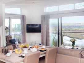 A dining area with a table set for breakfast at Milk Wood 3 Spa in Laugharne