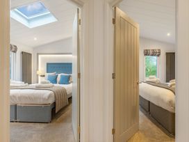 A bedroom with two beds and a window at Apex Spa in Laugharne