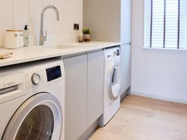 A laundry room with washing machines and a sink at Epic Spa in Laugharne